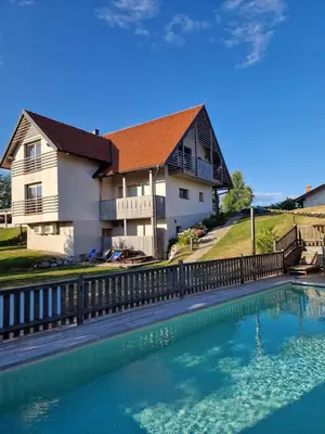 a house with a swimming pool in front of a house at Relax Guest House Marjanca in Rogaška Slatina