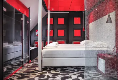 a bedroom with a white bed and red lighting at Hotel Lent in Maribor