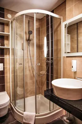 a bathroom with a shower and a sink at Hotel Lent in Maribor
