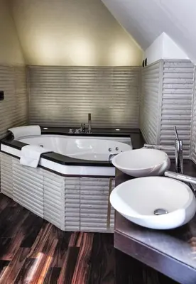 a large bathroom with two sinks and a tub at Hotel Lent in Maribor