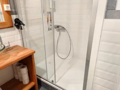 a shower with a glass door in a bathroom at BIT apartments in Ljubljana