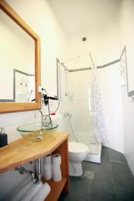 a bathroom with a glass sink and a toilet at BIT apartments in Ljubljana