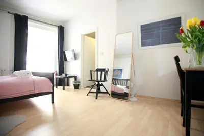 a bedroom with a bed and a mirror and a chair at BIT apartments in Ljubljana