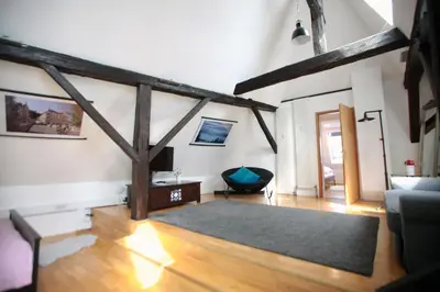 a living room with wooden beams on the walls at BIT apartments in Ljubljana