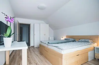 a bedroom with a large bed and a table at Apartma pri Boštjanu in Škofja Loka
