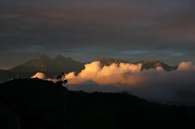 a group of mountains with clouds in front of them at Apartma pri Boštjanu in Škofja Loka