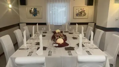 a dining room with a white table and white chairs at Villa Nena in Kranjska Gora