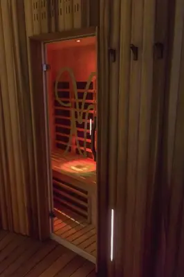 a glass door of a cabinet with a chair in it at Villa Nena in Kranjska Gora