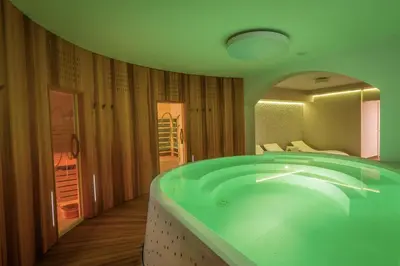 a large green bath tub in a room at Villa Nena in Kranjska Gora