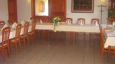 a large table in a room with wooden chairs at Tourist Farm Joannes in Maribor