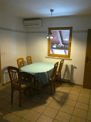 a dining room with a table and chairs and a window at Tourist Farm Joannes in Maribor