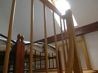 a spiral staircase with a light on the top at Tourist Farm Joannes in Maribor
