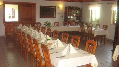 a group of tables and chairs in a restaurant at Tourist Farm Joannes in Maribor
