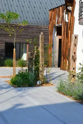 a building with wooden posts in front of it at Hotel Rakar in Trebnje