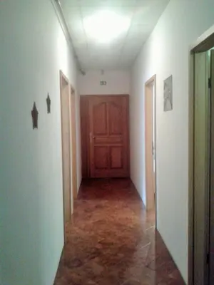an empty hallway with a wooden door in a room at Guesthouse Jersin in Logatec