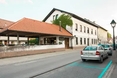 a car parked in front of a building on a street at Guesthouse Jersin in Logatec