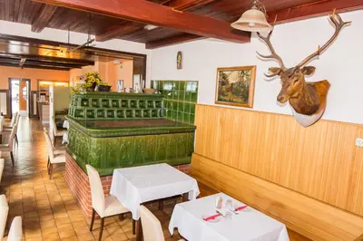 a restaurant with two tables and a deer head on the wall at Guesthouse Jersin in Logatec