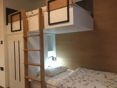 a bedroom with a bunk bed and a bunk ladder at Apartma Rogla - Gaber 98 in Resnik