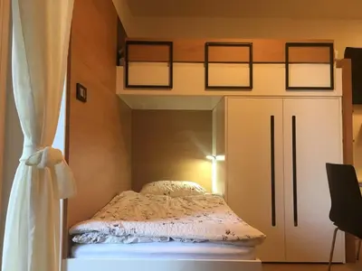 a bed in a room with a window and a curtain at Apartma Rogla - Gaber 98 in Resnik