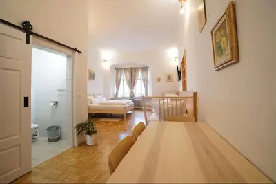 a living room with a table and a couch at Sobe Proštija in Ptuj