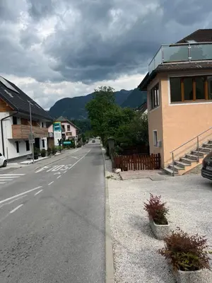 an empty street in a town with a building at Apartma Kemper in Bovec