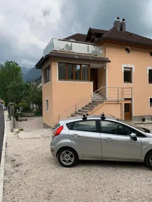 a silver car parked in front of a house at Apartma Kemper in Bovec