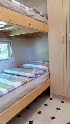 two bunk beds in a room with a window at Samson mobile house in Bled