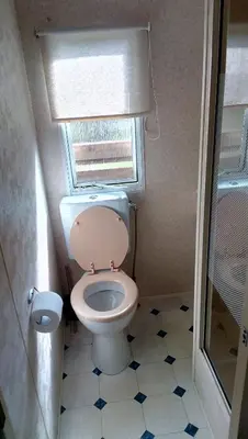 a small bathroom with a toilet and a window at Samson mobile house in Bled