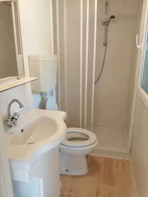 a bathroom with a toilet and a sink and a shower at Samson mobile house in Bled