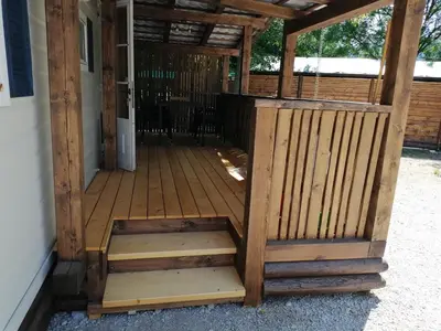 a wooden entrance to a building with a porch at Samson mobile house in Bled