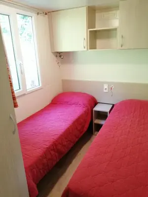 two beds in a room with red blankets at Samson mobile house in Bled