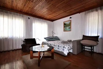 a bedroom with a bed and a table and a chair at Apartma Mika in Most na Soči