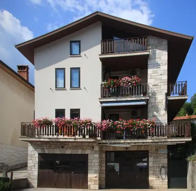 a building with flower boxes on its balconies at Apartma Mika in Most na Soči