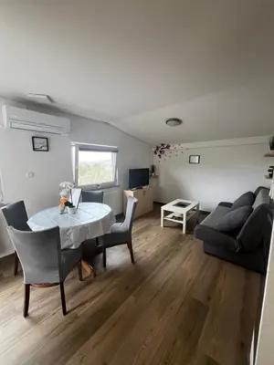 a living room with a table and a couch at apartma Golovec in Ljubljana