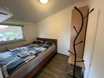 a bedroom with a bed and a window at apartma Golovec in Ljubljana