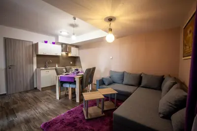 a living room with a couch and a table at apartma Golovec in Ljubljana