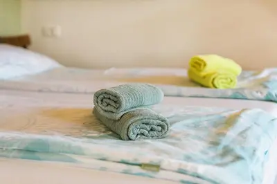 a pile of towels sitting on a bed at Pr' Petrču in Tolmin