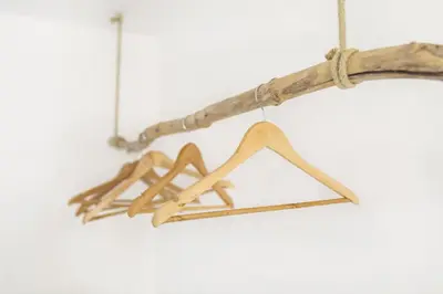 a bunch of wooden hangers hanging from a branch at Pr' Petrču in Tolmin