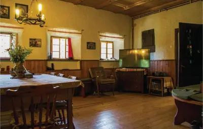 a living room with a table and a television at 4 Bedroom Amazing Home In Vrhnika in Vrhnika