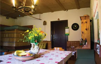 a table with a vase of flowers and a basket of fruit at 4 Bedroom Amazing Home In Vrhnika in Vrhnika