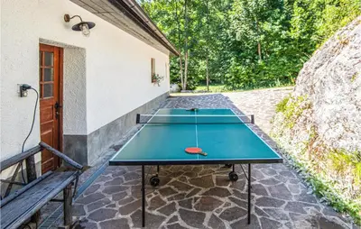 three ping pong tables sitting on a stone patio at 4 Bedroom Amazing Home In Vrhnika in Vrhnika