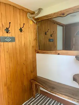 a room with a bench and a snake on the wall at Apartma Pr'Toman in Kamna Gorica