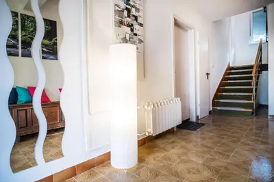 a living room with a staircase and a light fixture at Apartment Japka in Bovec