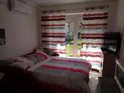 a bedroom with a bed with red and white blankets at Apartment Japka in Bovec