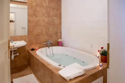 a bathroom with a tub and a sink at Villa Anton - The Old Dairy in Hrušica