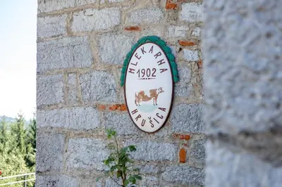a clock on the side of a brick wall at Villa Anton - The Old Dairy in Hrušica