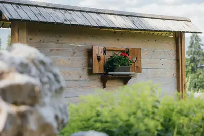 a building with a window with a potted plant on it at Alp Glamping Village in Radovljica