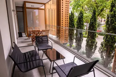 a balcony with chairs and tables on a building at Argo Apartments in Ljubljana