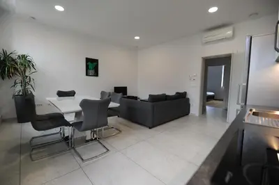 a living room with a table and a couch at Argo Apartments in Ljubljana