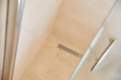 a shower with a glass door next to a shower at Hostel Delalut in Ravne na Koroškem